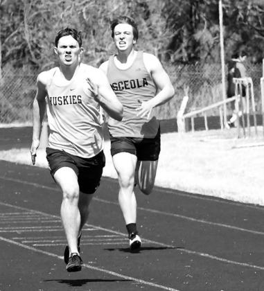 Gavin Dutton-Mofford (left) of Shelby-Rising City and Caleb Peterson of Osceola compete in the 400 meter dash.