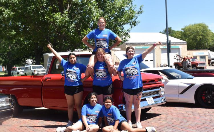 Above: HPC 2024-25 cheerleaders pose in front of one of the vehicles entered. Below: These entries were for the kids, a Flintstones vehicle and two kid-sized three-wheelers. Turn to the Polk page (7) for results. PCN photos by Beth Sparrow.